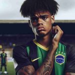 Realistic HD photo of a young athletic Black Brazilian football player expressing disappointment after a challenging game with a team from Paraguay